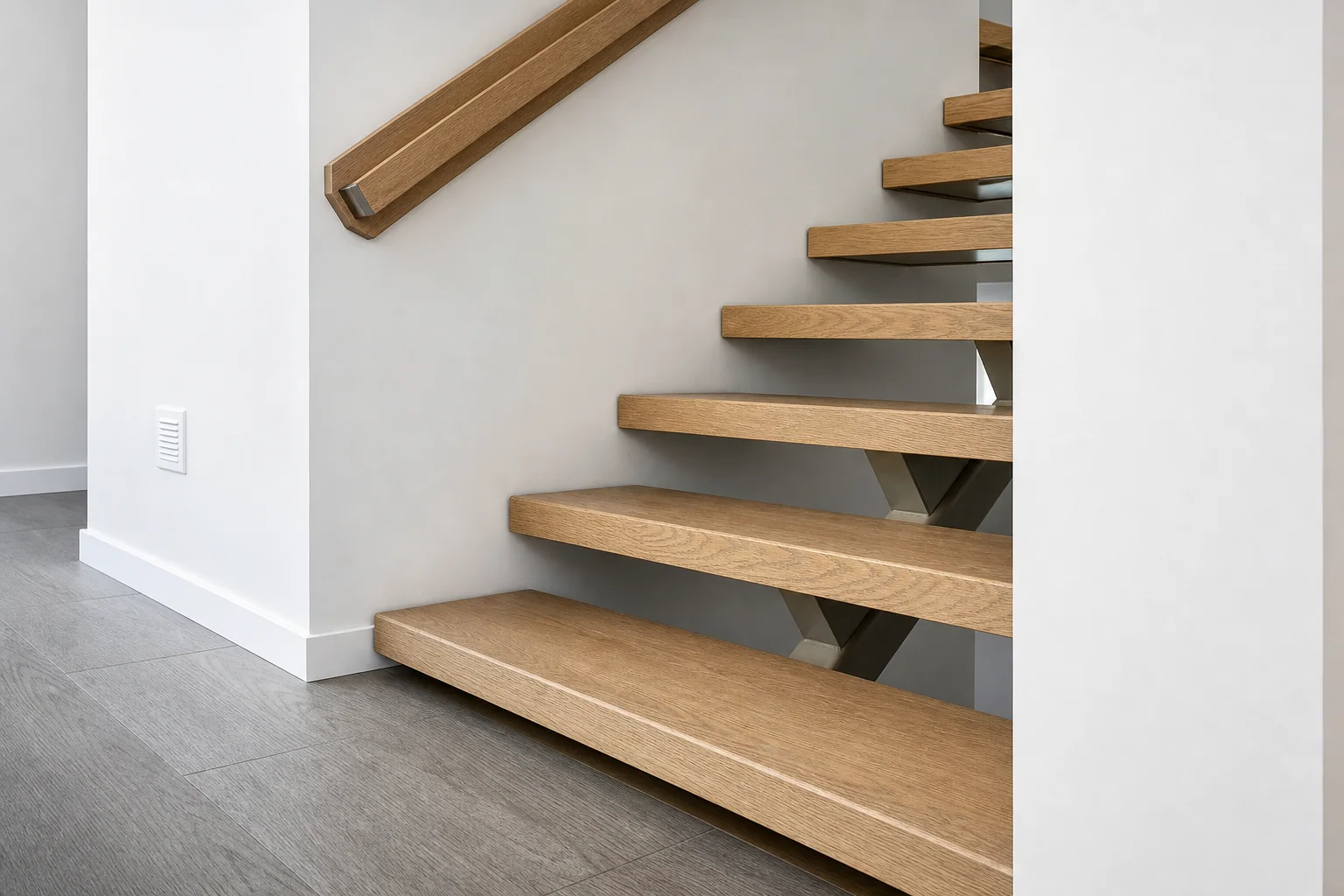 Floating oak staircase and matching handrail completed by HUFCO