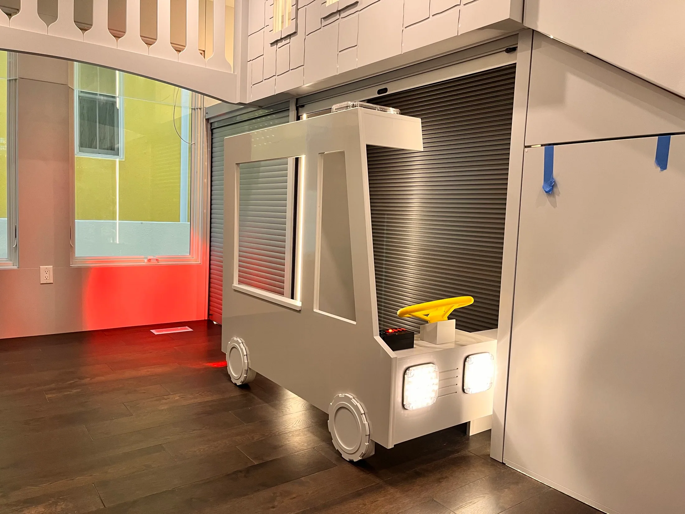 Custom child-size vehicle integrated into a HUFCO-designed playroom installation